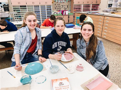 students glazing ceramics