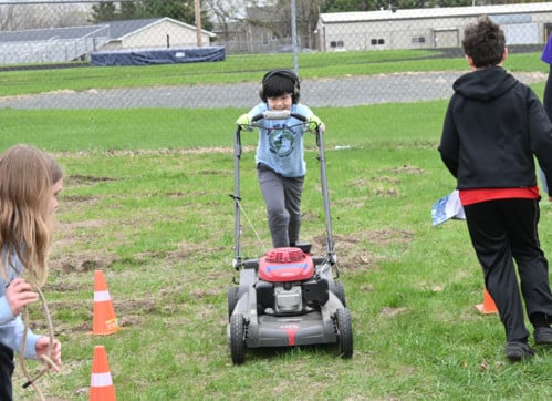 student practicing using the lawn mower