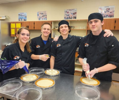 culinary arts students making a meal together