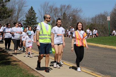 People walking with safety vests on