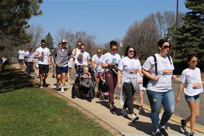 people walking with stomp the stigma shirts on