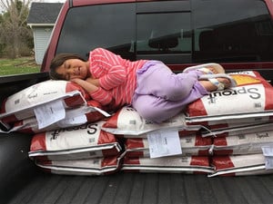 student in bed of truck