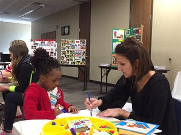 student learning at a desk with teacher