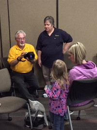 Staff member taking photo of student for the Child Development Days program