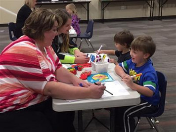 Students and teachers coloring together