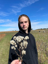 Student holding a plant