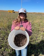 Student holding bucket