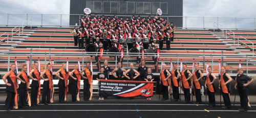 middle school band standing in the NRHS stadium bleachers